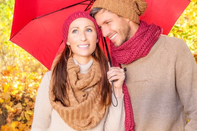 a couple having a date under a red umbrella