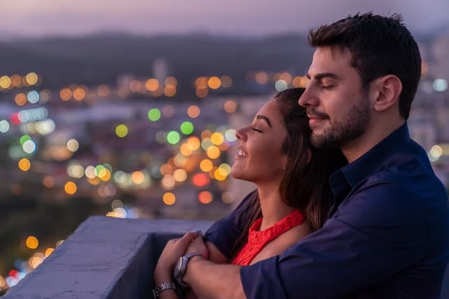 a couple enjoying an evening date on a rooftop