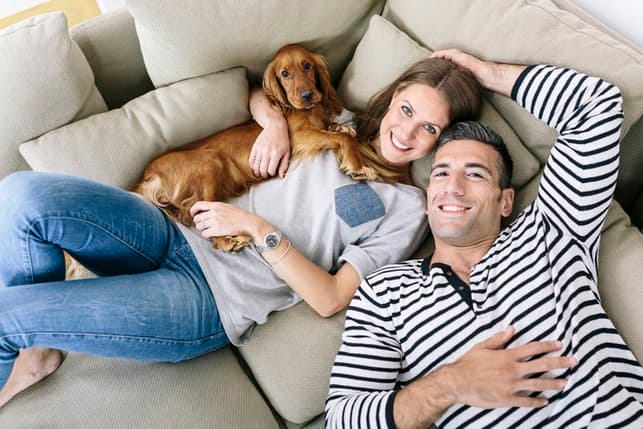 a couple with a dog relaxing at home