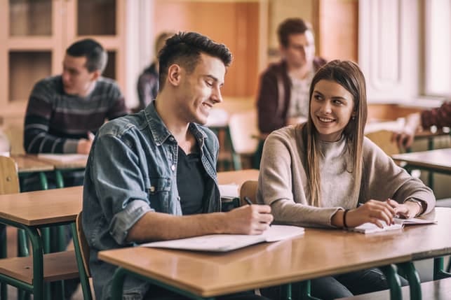 a young college students are talking while being in the classroom