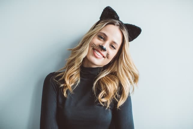 a young blonde girl with a funny cat makeup