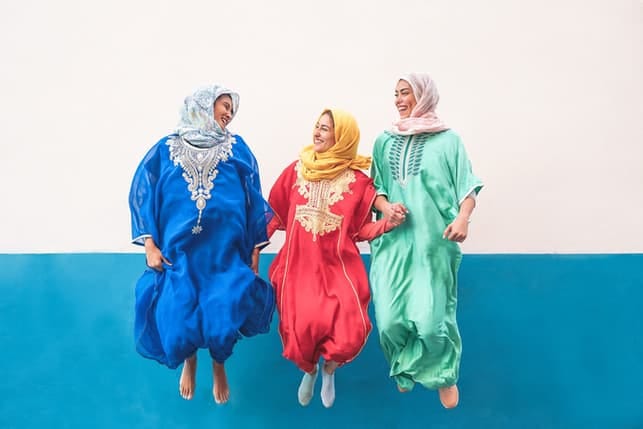 Muslim women having fun and jumping together