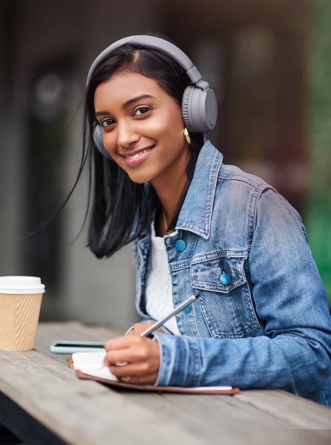 a portrait of a young modern Indian woman wearing headphones