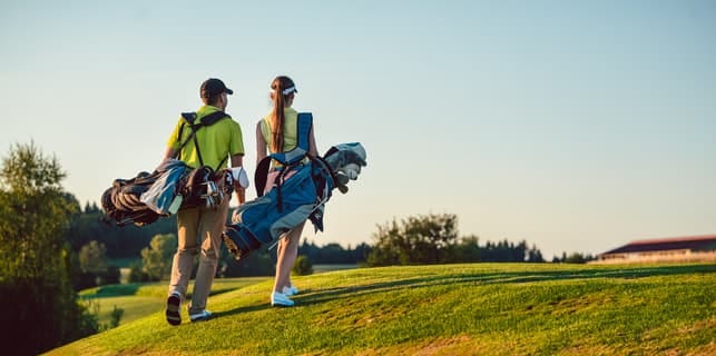 a young couple playing golf together