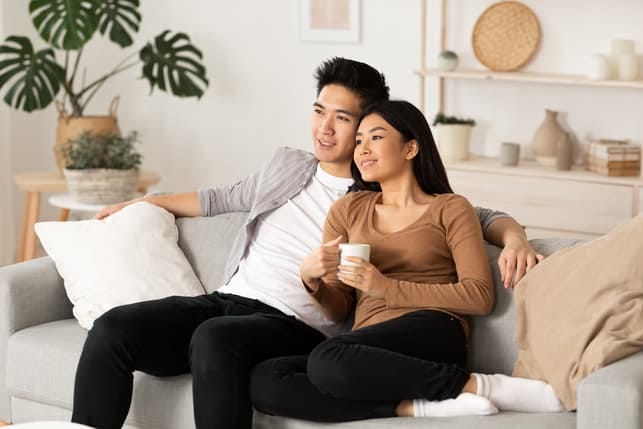 alt: an asian couple relaxing at home together