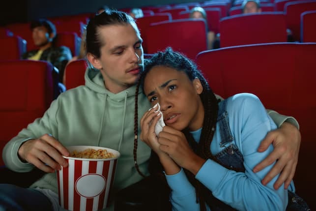 a girl is sad on a date at the cinema because of a sad movie