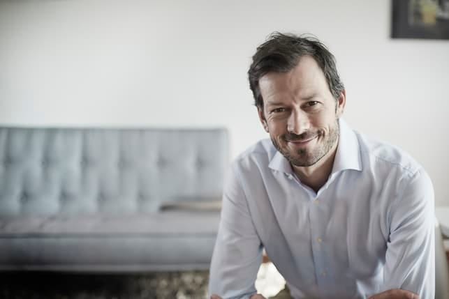 a middle-aged man smiling indoors