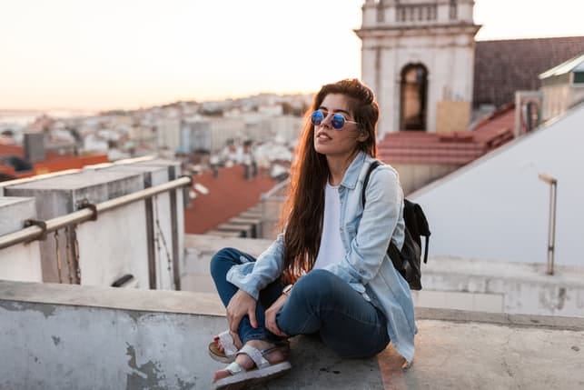 a young woman relaxes on a roof