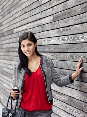 a modern indian woman posing outdoors