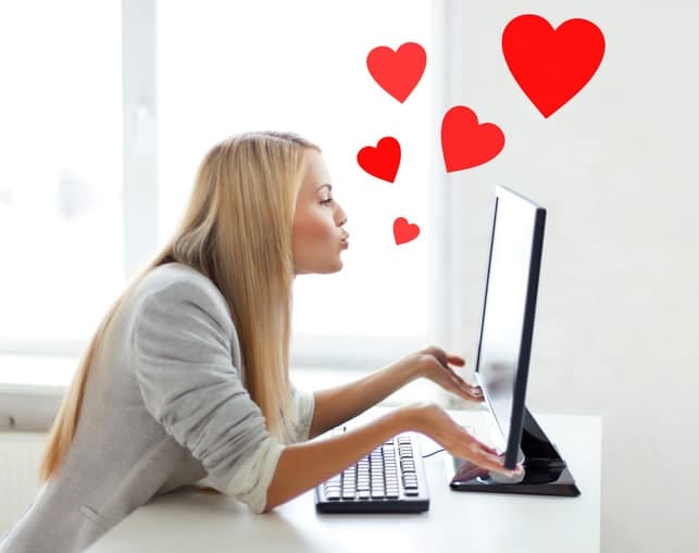 a woman enjoying online dating via her laptop