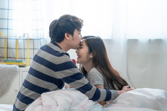 a young Asian couple kissing