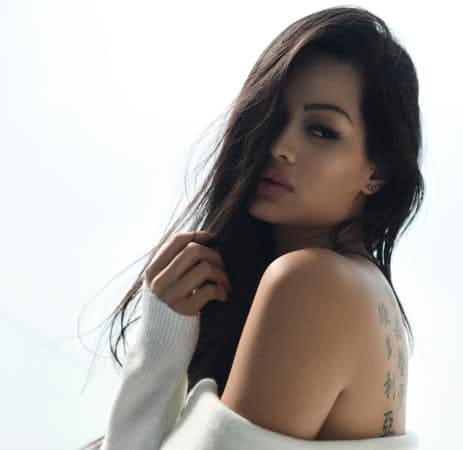a portrait of an attractive asian woman wearing a white sweater