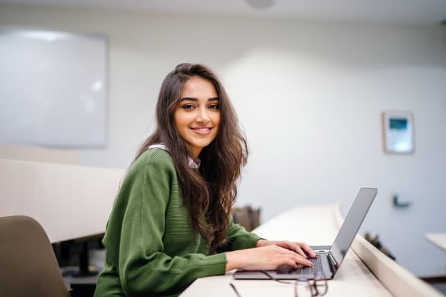 a young girl using her laptop