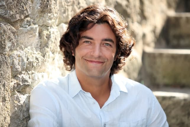 a handsome french man smiling