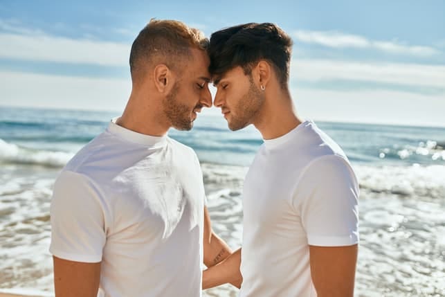 a gay couple enjoying each others company on the seaside