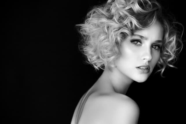 a black-and-white picture of a beautiful curly woman