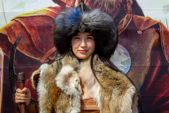 a beautiful Mongolian woman wearing an ethnic-inspired costume on a festival