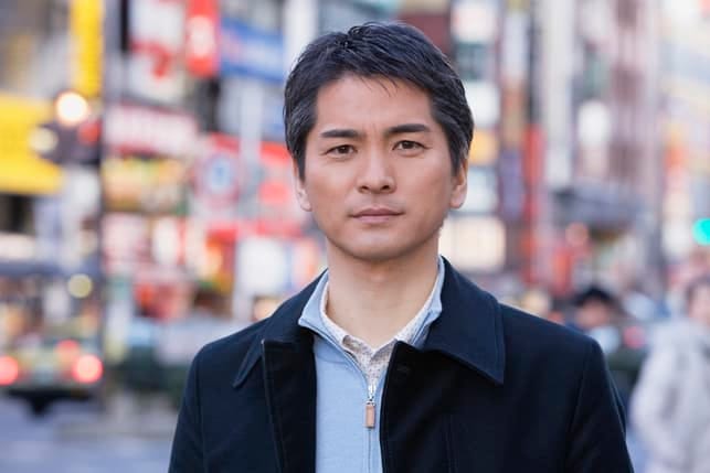 a portrait of a serious middle-aged asian man