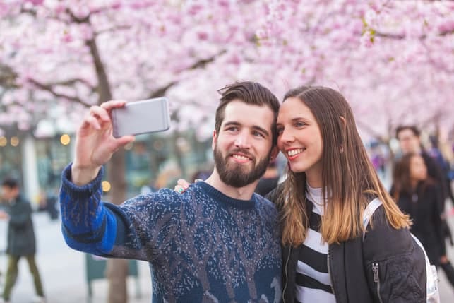 a nice couple taking a selfie outdoors together