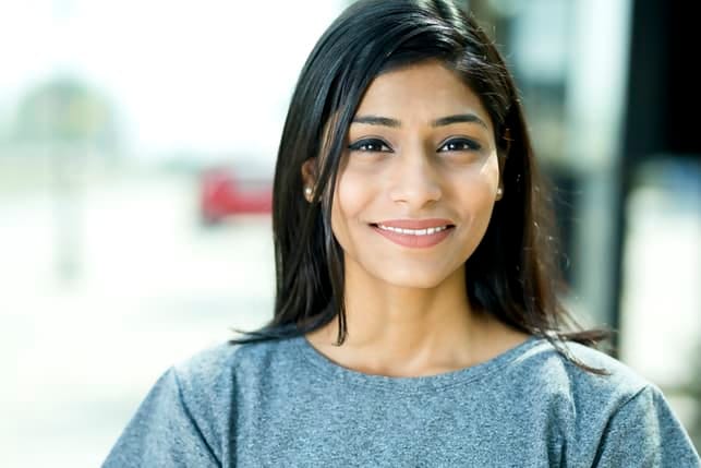 a middle-aged asian woman is smiling