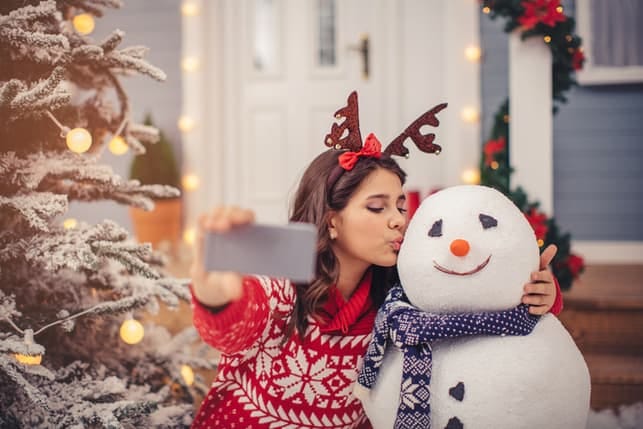 Charming girl making a Christmas selfie